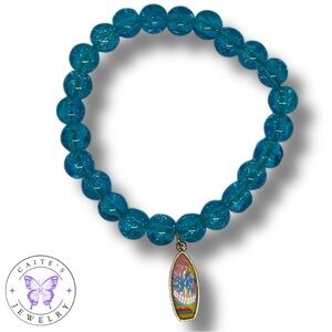 Handmade Gold Elastic Bracelet with Blue Glass Beads and a Surfboard Charm